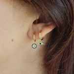 A woman modeling the Evie Hoops 14K Gold Plated with an evil eye design