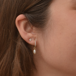 Detail of Kayla 14K gold-plated hoop earrings featuring pearl accents
